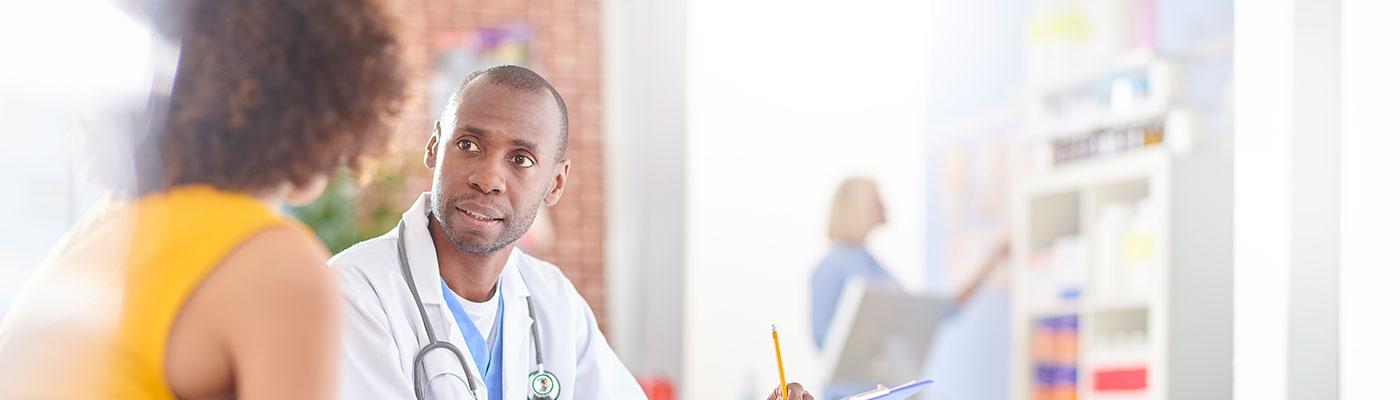 Young doctor talking to a patient.